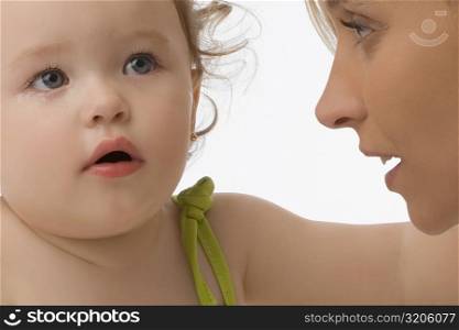 Close-up of a mid adult woman looking at her daughter