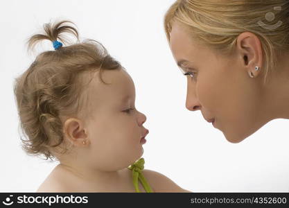 Close-up of a mid adult woman looking at her daughter