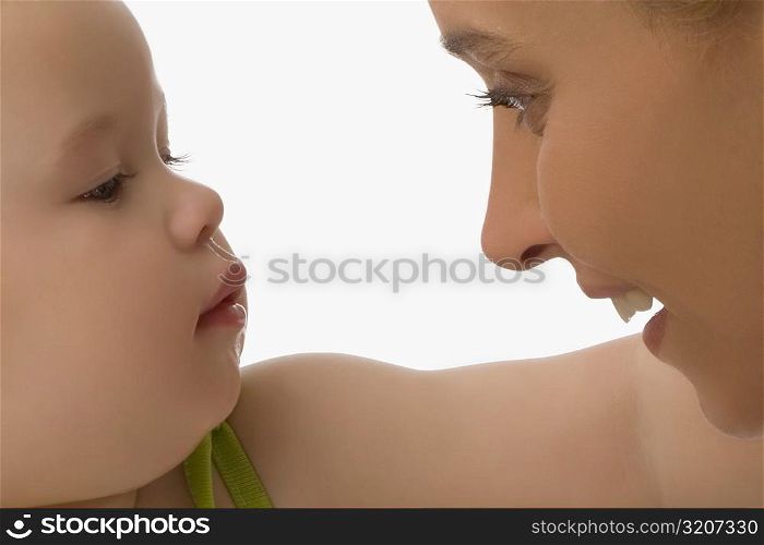 Close-up of a mid adult woman looking at her daughter and smiling