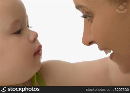 Close-up of a mid adult woman looking at her daughter and smiling