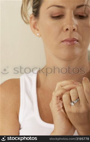 Close-up of a mid adult woman looking at her fingernails