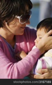 Close-up of a mid adult woman looking at her son