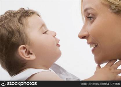 Close-up of a mid adult woman looking at her son and smiling