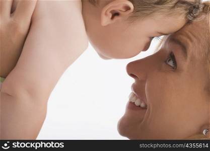 Close-up of a mid adult woman looking at her son and smiling