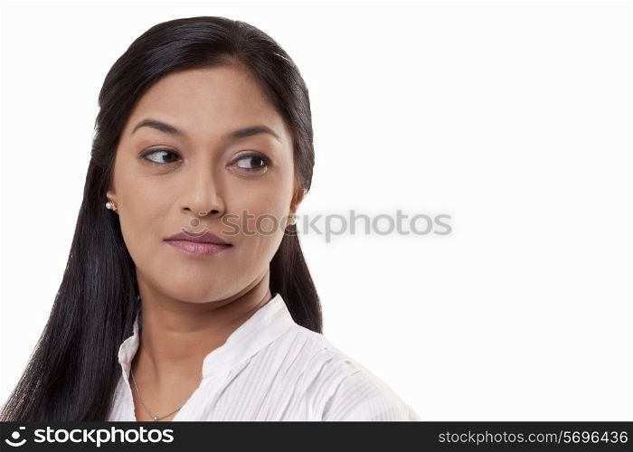 Close-up of a mid adult woman looking away over white background