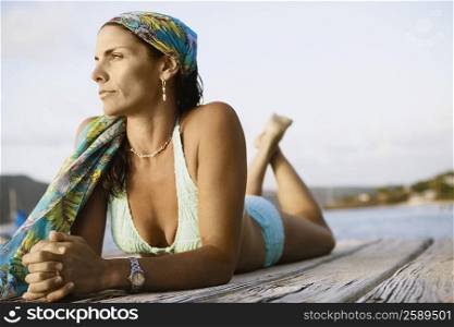 Close-up of a mid adult woman lying on a pier