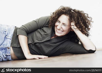 Close-up of a mid adult woman lying on the floor with her eyes closed