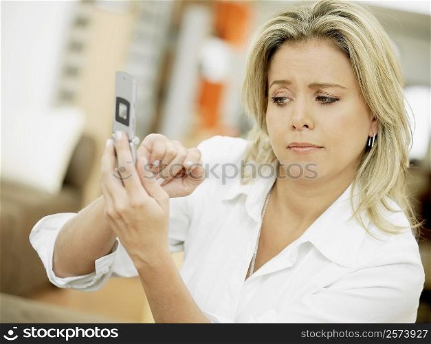 Close-up of a mid adult woman operating a mobile phone