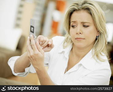 Close-up of a mid adult woman operating a mobile phone