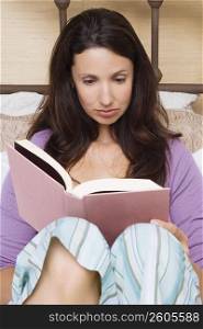 Close-up of a mid adult woman reading a book