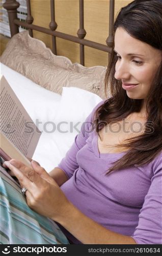 Close-up of a mid adult woman reading a book