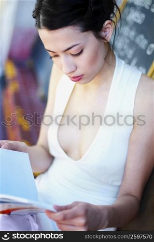 Close-up of a mid adult woman reading a menu
