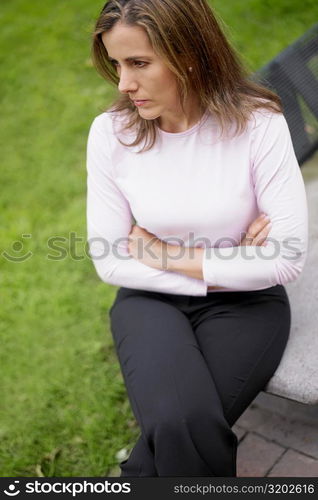 Close-up of a mid adult woman sitting on a bench