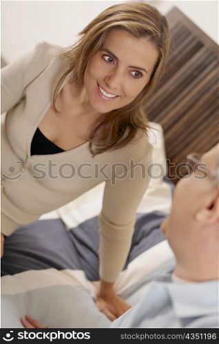 Close-up of a mid adult woman sitting on the bed