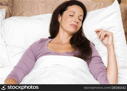 Close-up of a mid adult woman sleeping on the bed