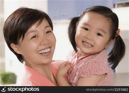 Close-up of a mid adult woman smiling with her daughter
