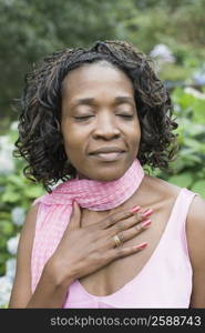 Close-up of a mid adult woman smiling with her eyes closed