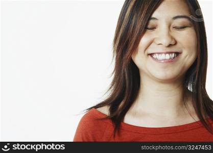 Close-up of a mid adult woman smiling with her eyes closed