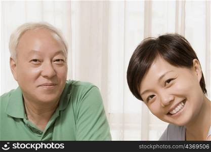 Close-up of a mid adult woman smiling with her father