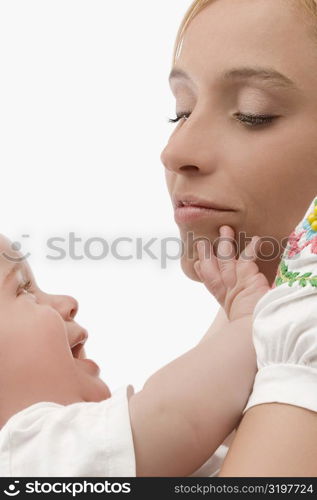 Close-up of a mid adult woman smiling with her son