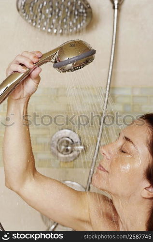 Close-up of a mid adult woman taking a shower