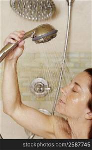 Close-up of a mid adult woman taking a shower