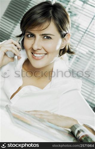 Close-up of a mid adult woman talking on a mobile phone and smiling