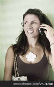 Close-up of a mid adult woman talking on a mobile phone and smiling