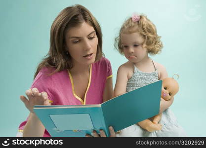 Close-up of a mid adult woman teaching her daughter