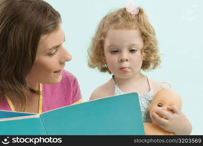 Close-up of a mid adult woman teaching her daughter