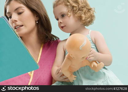 Close-up of a mid adult woman teaching her daughter