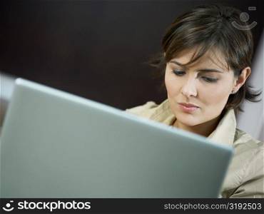 Close-up of a mid adult woman using a laptop