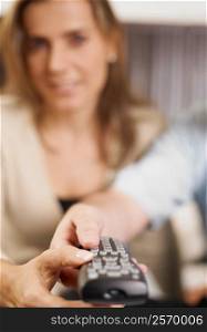 Close-up of a mid adult woman using a remote control