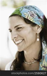 Close-up of a mid adult woman wearing a headscarf and smiling