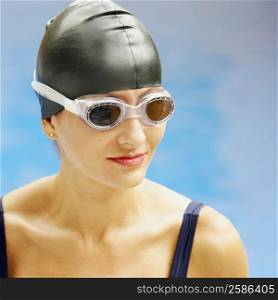 Close-up of a mid adult woman wearing swimming goggles