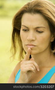 Close-up of a mid adult woman with her hand on her chin