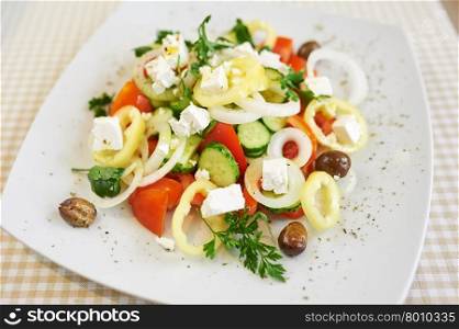close up of a mixed vegetable salad on white plate