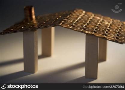 Close-up of a model of a house made with coins