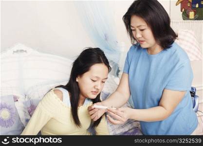Close-up of a mother checking her daughter&acute;s temperature