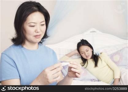 Close-up of a mother checking her daughter&acute;s temperature