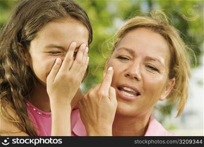 Close-up of a mother gesturing to her daughter