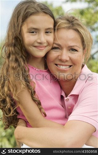 Close-up of a mother hugging her daughter