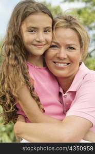 Close-up of a mother hugging her daughter