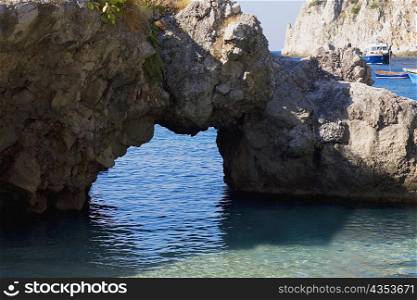 Close-up of a natural arch in a rock formation, Faraglioni Rocks, Capri, Campania, Italy