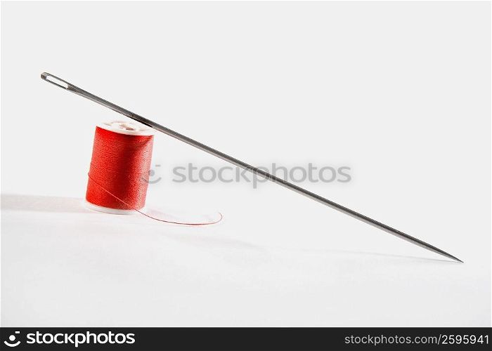 Close-up of a needle with a spool of thread