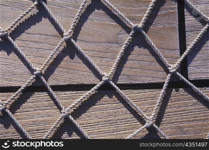 Close-up of a net in front of wooden planks