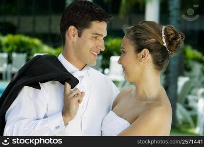 Close-up of a newlywed couple facing each other and smiling