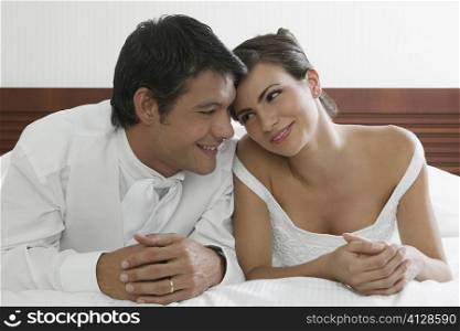 Close-up of a newlywed couple lying on the bed