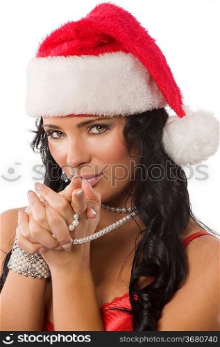 close up of a nice brunette with pearl necklace and a red christmas hat looking in camera