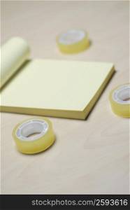 Close-up of a notepad with three adhesive tapes